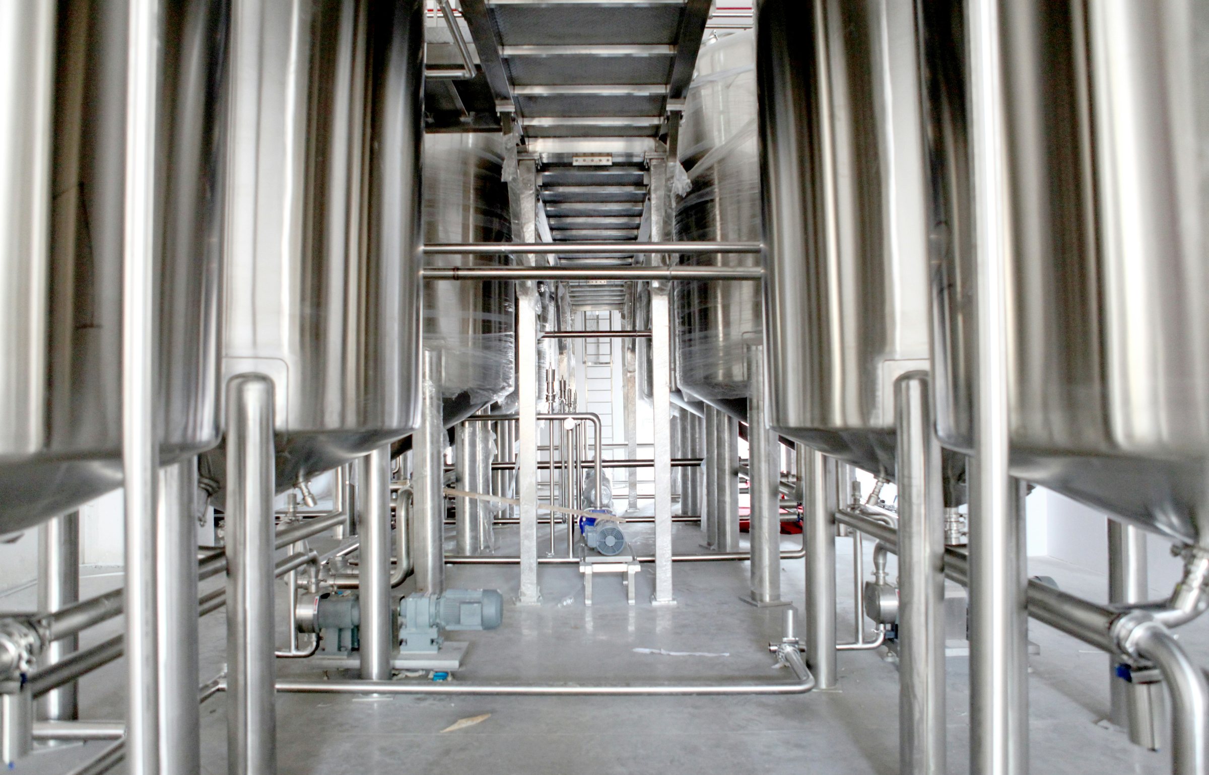 Stainless-steel process vessels and pipework in a clean production hall