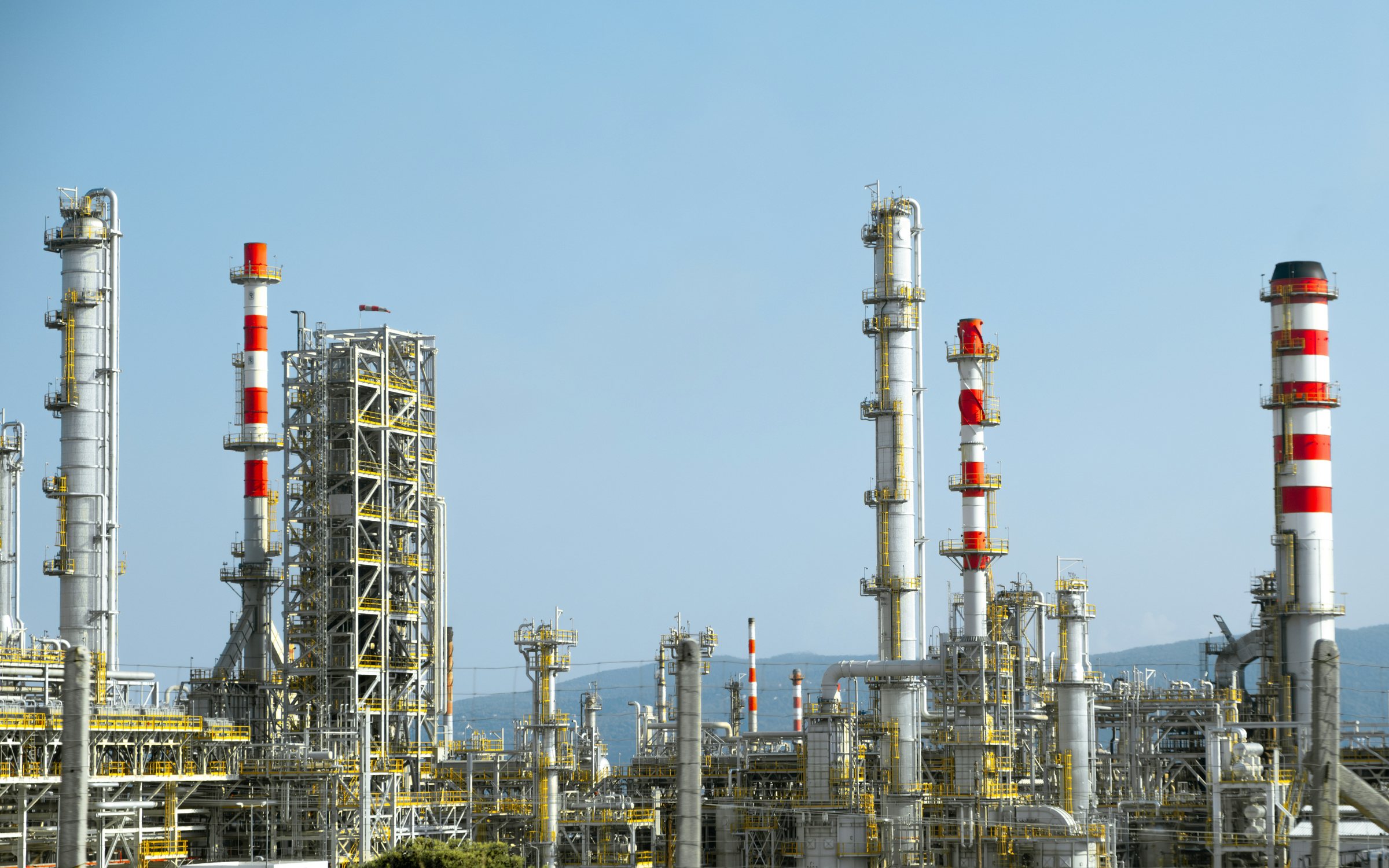 Process columns, stacks and pipe racks at a chemical processing complex in daylight