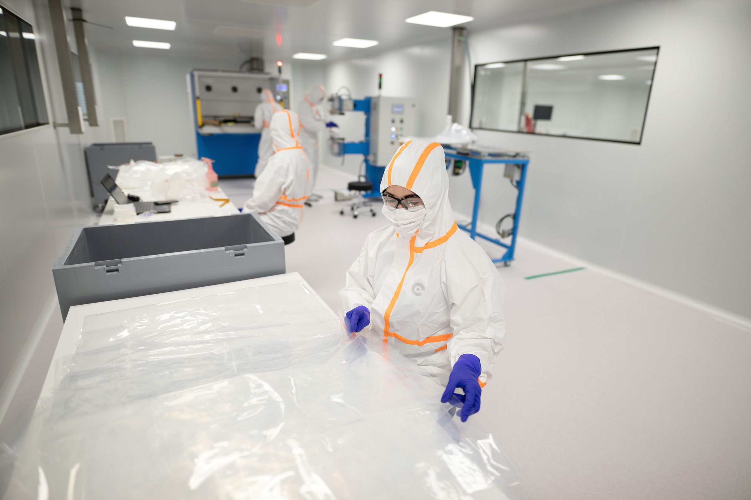 Operator in a protective suit working in a pharmaceutical cleanroom