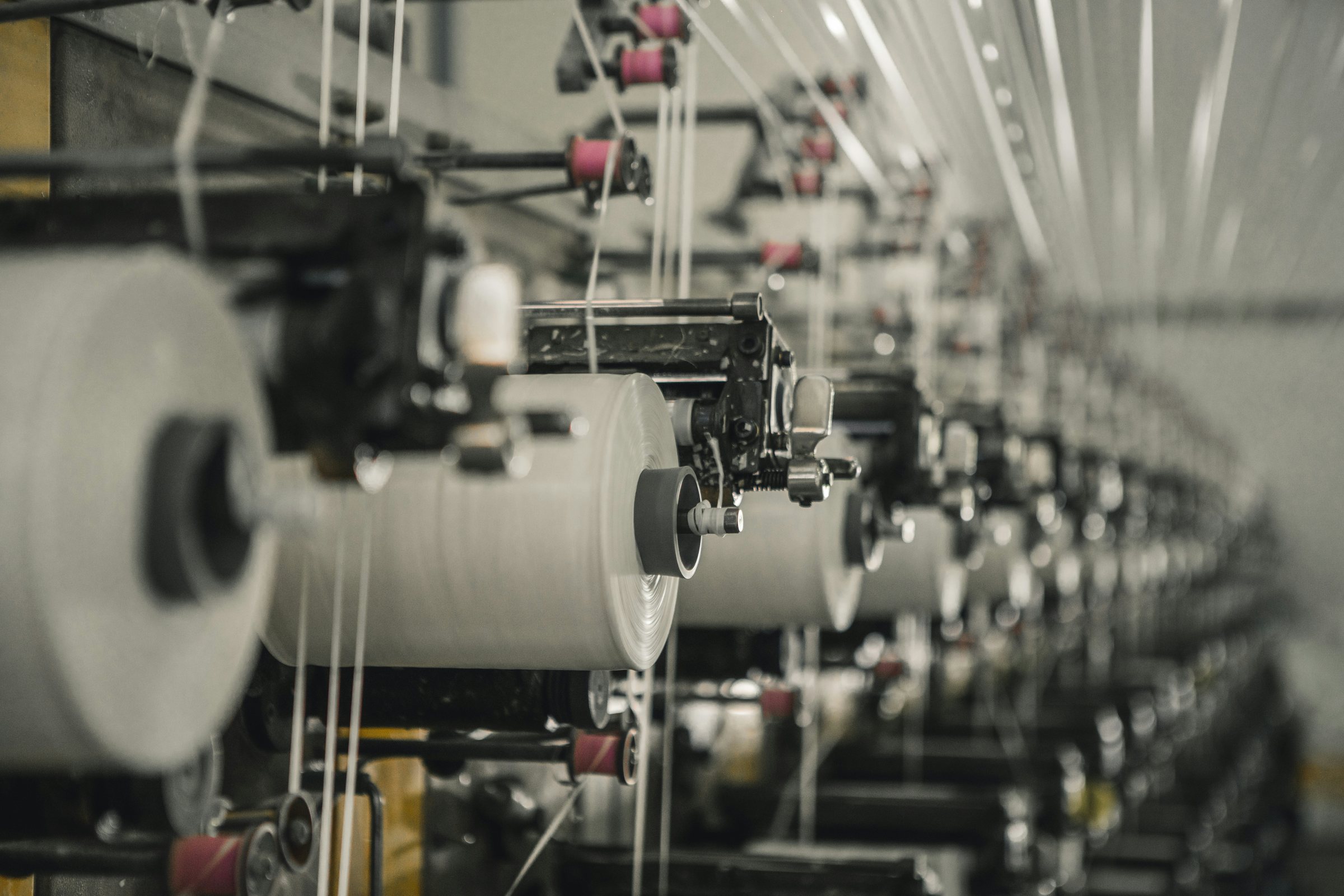 Rows of yarn packages running on textile machinery