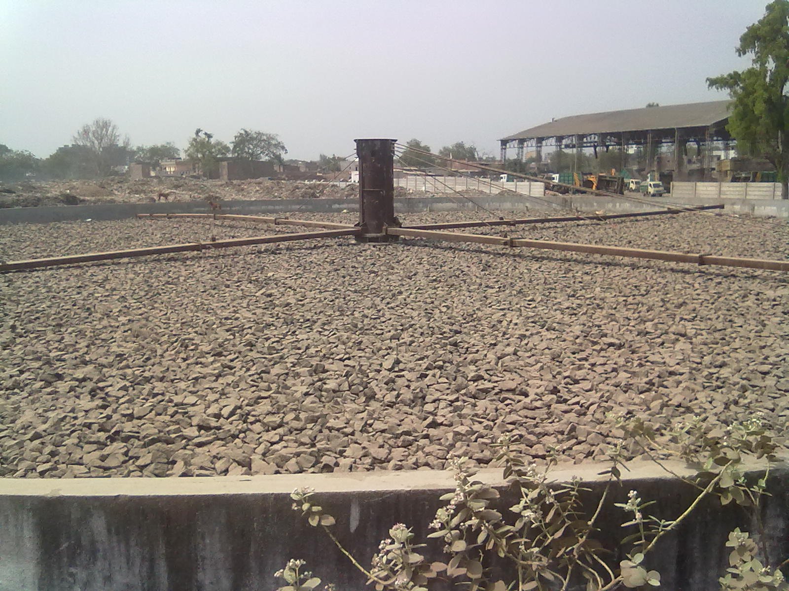 Stationary rock media in a fixed-film wastewater treatment bed